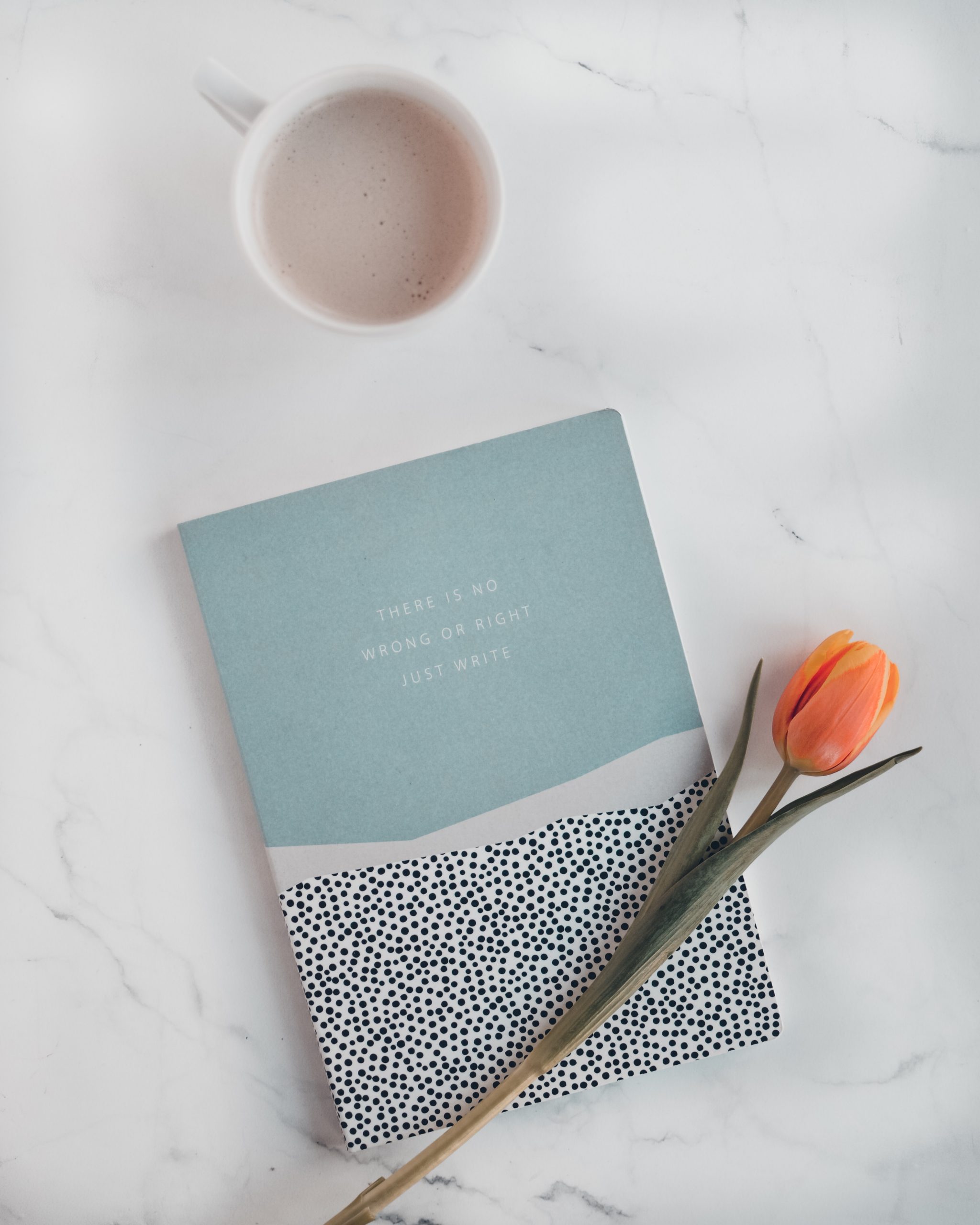 Journal Journal on table with flower and beverage